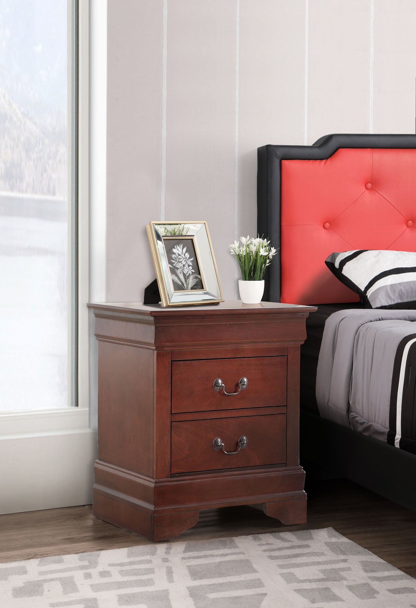 Charming Cherry Finish Nightstand with three drawers and brass handles beside a red upholstered bed