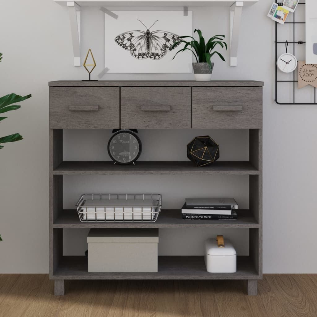 Three-drawer light grey solid pine and MDF console table with open shelves, featuring clock, plant and basket decor